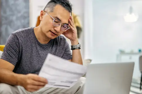 photo of man worried about bills